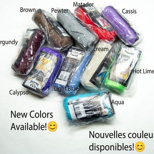 May include: A collection of ten individually wrapped yarn skeins in various colours including burgundy, brown, pewter, matador red, cassis, calypso, light blue, cream, hot lime, and aqua. Each package features a label with the brand name Prymtex.