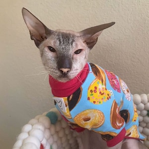 Donut t-shirt for dog or cat, pullover, sweatshirt, jumper. Multicolored donuts pattern on aqua background