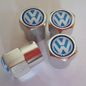 May include: Set of four silver tyre valve stem caps with a blue and white Volkswagen logo.