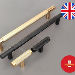 May include: Three cabinet knobs and pulls in gold and black finishes. The knobs and pulls have a textured diamond pattern. The knobs are small and the pulls are long.