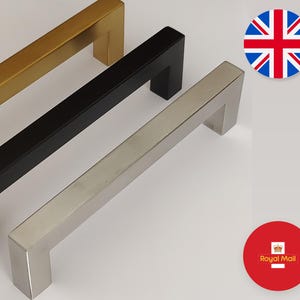 May include: Three square-shaped cabinet handles in gold, black, and silver. The image shows a British flag and a Royal Mail logo. The handles are designed for a modern aesthetic.
