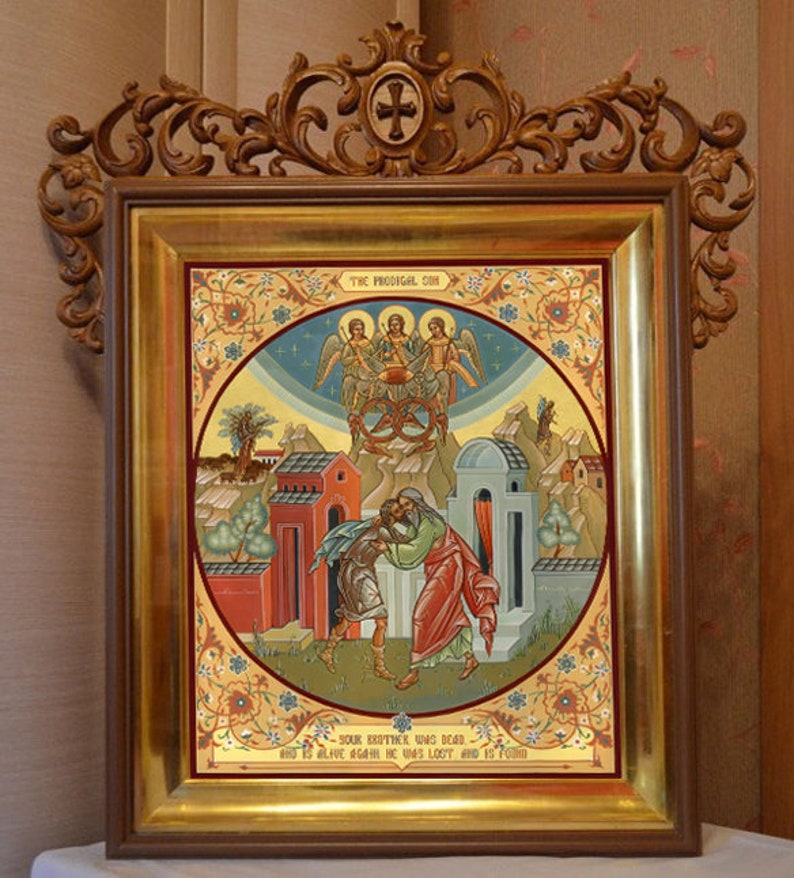 May include: A framed icon depicting the biblical parable of the Prodigal Son. The icon is painted in a traditional style with gold accents and features a scene of the father embracing his returning son. The text at the bottom reads "Your brother who was dead and is alive again he was lost and is found."