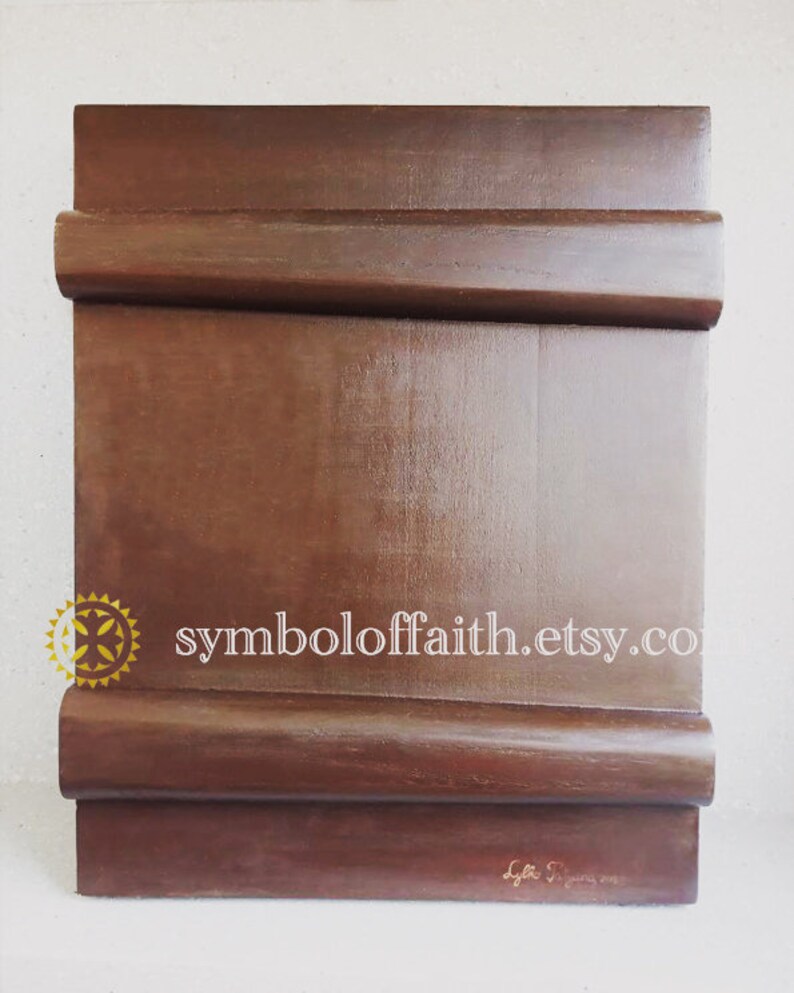 May include: A dark brown wooden icon board with a rounded edge and a gold symbol of faith in the top left corner. The text "symboloffaith.etsy.co" is printed in white on the board. The board is signed "Lyttle S. January 2019" in the bottom right corner.