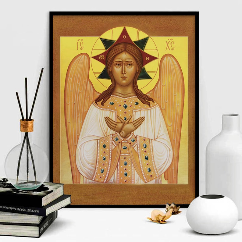 May include: A religious icon depicting an angel with golden wings and a halo. The angel is wearing a white robe with gold trim and has a serene expression. The icon is painted in a traditional style with vibrant colours.