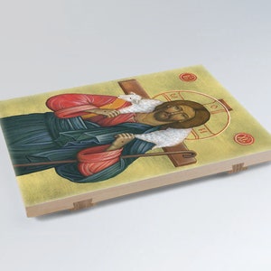 May include: A religious icon depicting Jesus Christ as the Good Shepherd. He is carrying a lamb on his shoulders and holding a staff. The icon is painted in a traditional style with vibrant colours and gold accents.