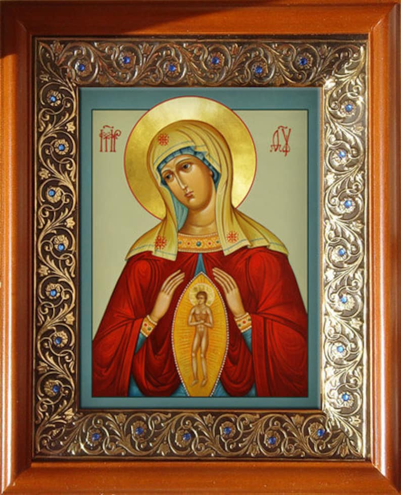 May include: A religious icon depicting the Virgin Mary holding a small figure of Jesus Christ in her arms. The icon is painted in a traditional style with gold accents and a blue background.