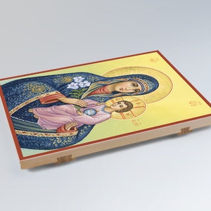 May include: A religious icon depicting the Virgin Mary holding the baby Jesus. The icon is painted in a traditional style with vibrant colors and intricate details. The background is a yellow-gold color.