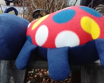 Hand made plush stuffed ladybug.  Very soft huggable and adorable.  It could even be a pillow.