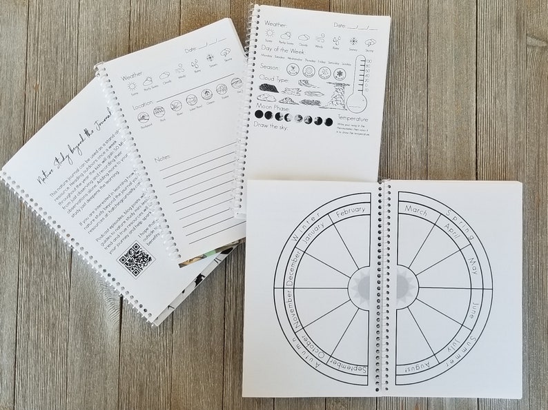 May include: White spiral-bound nature study journals with weather, moon phase, and seasonal cycle diagrams. One journal has the text "Nature Study Beyond the Journal". The journals are open to display the interior pages.