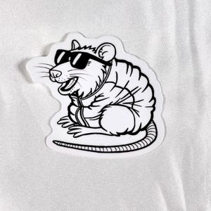 May include: Black and white line art sticker of a rat wearing sunglasses and a jacket. The rat is sitting down with its tail curled around its body.