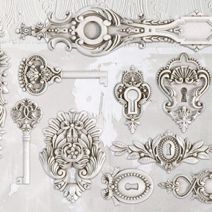 May include: A collection of white ornate keyhole and key designs with intricate details. These decorative elements are perfect for adding a touch of vintage charm to any project.