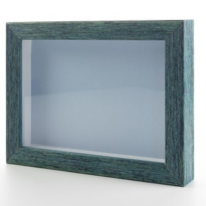 May include: A teal blue picture frame with a glass front and a wood grain finish.