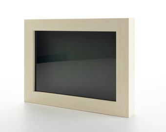 May include: A rectangular wooden picture frame with a light beige finish. The frame has a dark interior and is set against a white background. The frame is designed to hold a photograph or artwork.