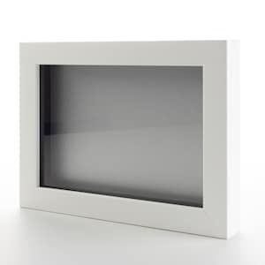 May include: A white picture frame with a clear glass front. The frame is sitting on a white surface.