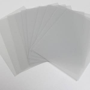 May include: A stack of clear plastic sheets, likely for crafting or protecting surfaces.
