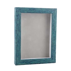 May include: A teal blue picture frame with a wood grain finish. The frame is empty and ready to display a photo or artwork.