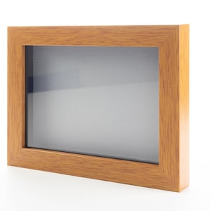 May include: A wooden picture frame with a light brown finish. The frame is empty and ready to display a photo or artwork.