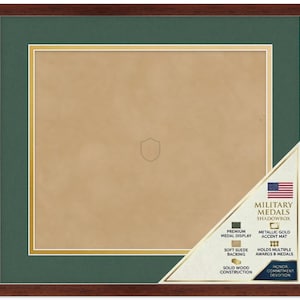 May include: A square shadowbox display case with a dark brown wood frame, a deep green mat, and a metallic gold accent border. The interior features a tan suede backing with a faint shield outline. A corner label displays the text Military Medals Shadowbox.