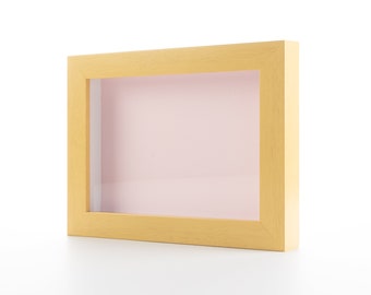 May include: A light wood picture frame with a light pink mount.