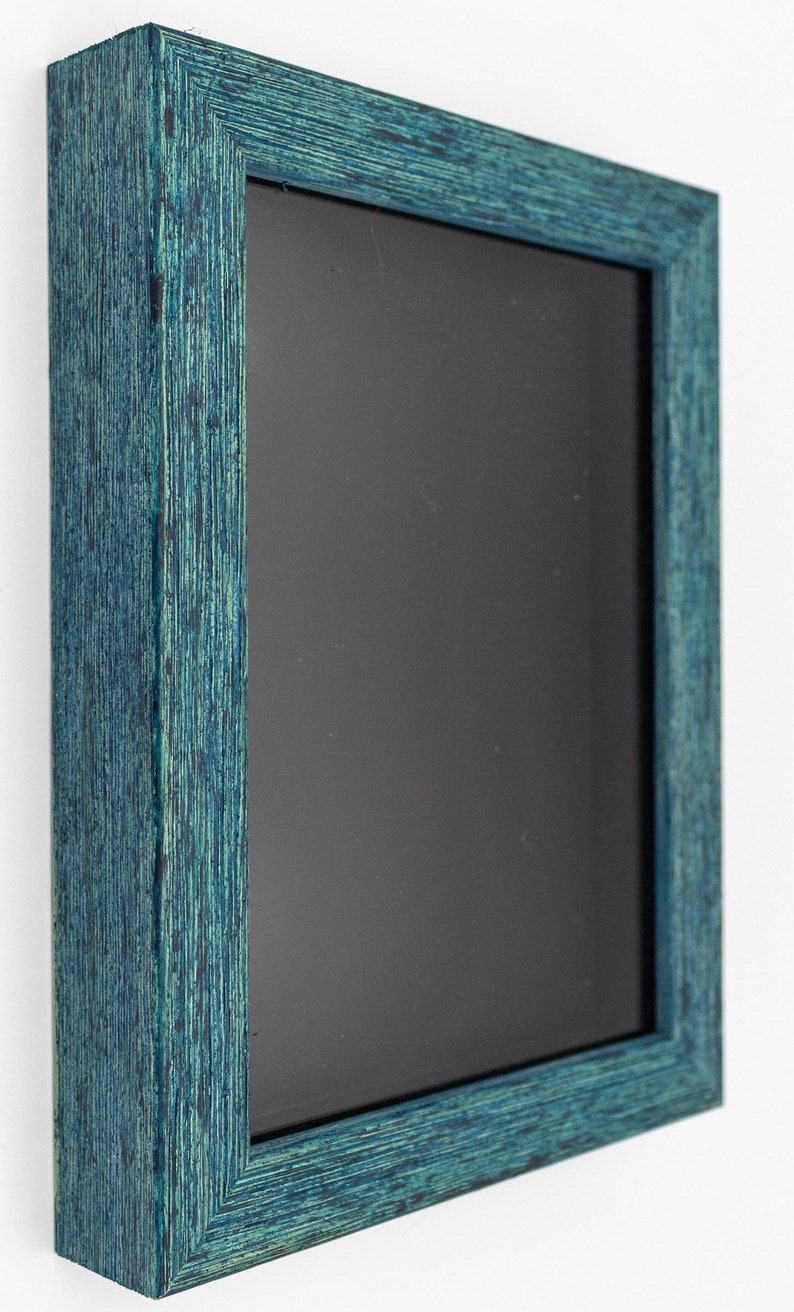 May include: A teal blue picture frame with a black mat. The frame is made of wood and has a distressed finish.