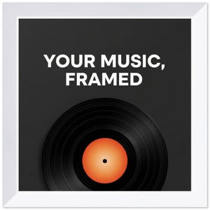 May include: A square wall art piece featuring a black vinyl record with a bright orange center label, set against a dark gray background. The text "YOUR MUSIC, FRAMED" is printed in white capital letters above the record, all inside a white frame.