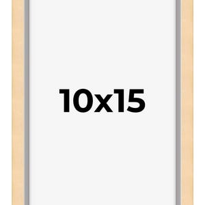 May include: A natural wood picture frame with a light gray mat. The frame is 10 inches by 15 inches.