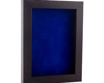May include: A dark brown wooden shadow box with a blue velvet interior. The box has a simple design and is perfect for displaying small items.