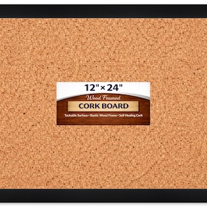 May include: A rectangular cork board with a black frame and a tan, textured tackable surface. A central label displays the text 12" x 24" Wood Framed CORK BOARD, noting a tackable surface, wood frame, and self-healing cork material.
