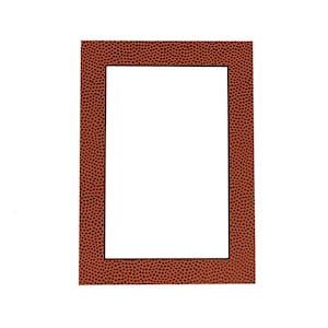 May include: A brown picture frame with a basketball texture. The frame has a black border and a white interior.