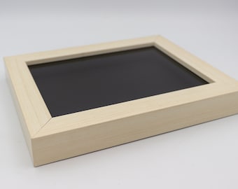 May include: A light wood picture frame with a black mat. The frame is made of a simple, clean design.
