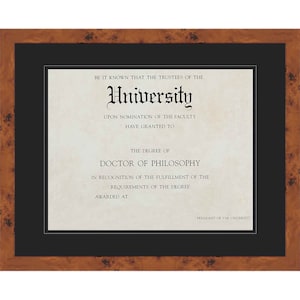 May include: A framed diploma with a brown wooden frame and a black mat. The diploma is cream-colored with black text, including the word "University" in a decorative font. The text reads "Doctor of Philosophy".