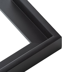 May include: Close-up of a black picture frame with a beveled edge. The frame is made of wood and has a smooth finish.