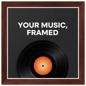 May include: A square wall art piece featuring a dark brown wood-grain frame. The center displays a black vinyl record with a solid orange circular label. Above the record, the white text reads: YOUR MUSIC, FRAMED, set against a dark gray background.
