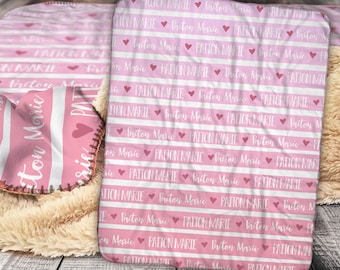 May include: Pink and white striped fleece blanket with the name "Paiton Marie" repeated in white text with pink hearts.