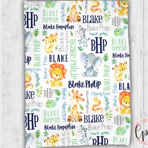 May include: White baby blanket with a repeating pattern of jungle animals, including giraffes, lions, and elephants. The blanket features the name "Blake Philip" and the initials "BHP" in navy blue and green.