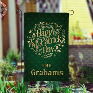 May include: Green garden flag with gold lettering that says "Happy St. Patrick's Day" with a shamrock design. The flag also has the text "The Grahams" in gold lettering.