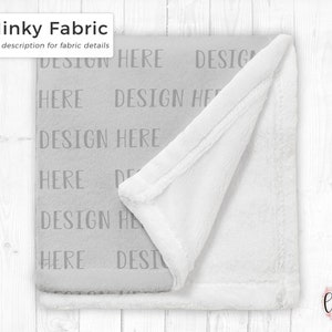 May include: A soft, gray minky fabric blanket with the text "DESIGN HERE" repeated across the surface. The blanket has a white, plush underside and a white border. The text "Minky Fabric" is in the upper left corner.