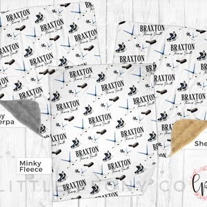 May include: A white baby blanket with a hockey theme. The blanket features a repeating pattern of hockey skates and sticks with the name "Braxton" and the text "Thomas Smith". The blanket is available in three different fabric options: gray sherpa, minky fleece, and tan sherpa.