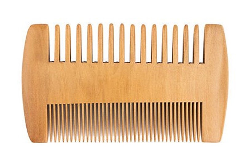 May include: A wooden comb with two rows of teeth. The comb is light brown and has a rounded shape.