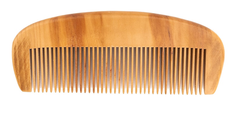 May include: A wooden comb with a natural brown finish and a curved shape. The comb has fine teeth and is designed for detangling and styling hair.