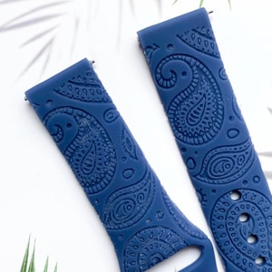 May include: Two blue silicone watch bands with a paisley pattern. The bands are made of a soft, flexible material and have a comfortable fit.