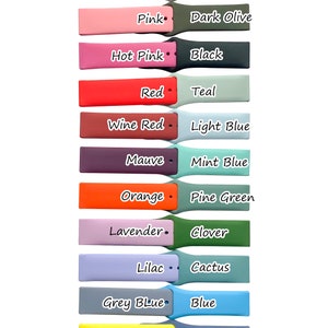May include: A variety of silicone watch bands in different colors, including pink sand, vintage rose, pink, hot pink, red, wine red, mauve, orange, lavender, lilac, grey blue, lemon yellow, bright yellow, and green. Each band is paired with a contrasting color band on the right side, with colors such as white, fog grey, dark olive, black, teal, light blue, mint blue, pine green, clover, cactus, blue, Alaskan blue, royal blue, and navy blue.