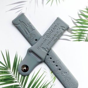 May include: Grey silicone watch band with a Mickey Mouse design and the text "If you can dream it, you can do it."  "Walt Disney"