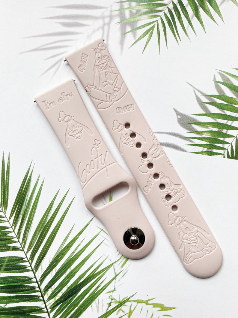 May include: Two pink silicone watch bands with a white embossed design of Goofy. One band says "I'm Goofy" and the other says "Goofy".