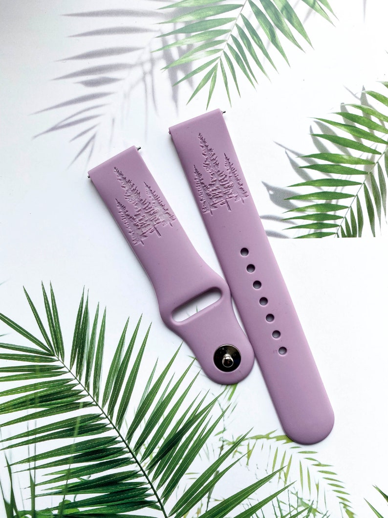 May include: Two lilac purple silicone watch bands with an embossed tree design.