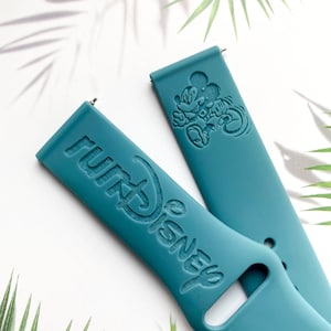 May include: Two teal blue silicone watch bands with a Mickey Mouse design and the text "Disney" embossed on them.