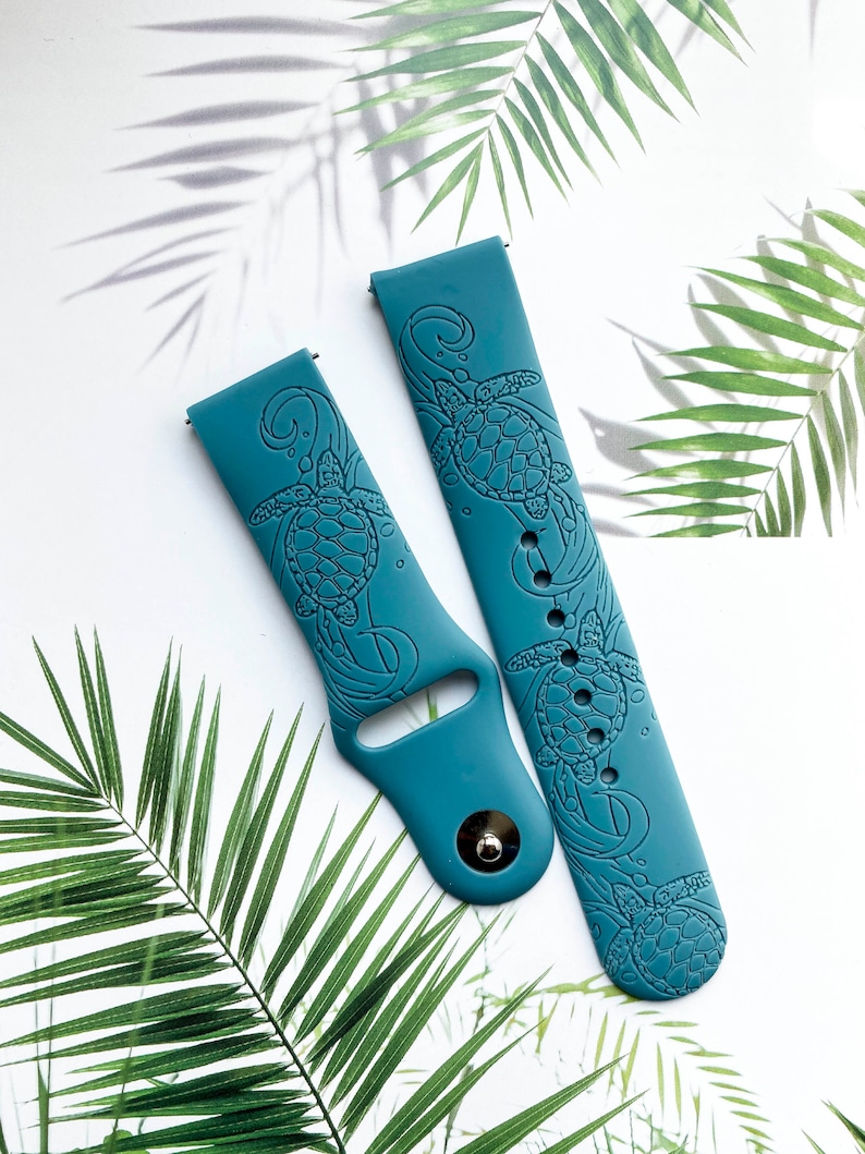 May include: Two teal blue silicone watch bands with a sea turtle design. The bands are made of soft, flexible silicone and feature a detailed sea turtle design.