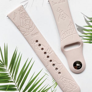 May include: Two pink silicone watch bands with a Goofy character design. One band has the text "I'm Goofy" and the other has multiple images of Goofy.