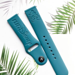 May include: Two teal blue silicone watch bands with a Mickey Mouse design and the text "WALT DISNEY" embossed on one band.