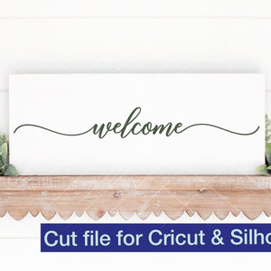 May include: White sign with the word "welcome" written in cursive script on a wooden shelf with green plants on either side. Cut file for Cricut & Silhouette.